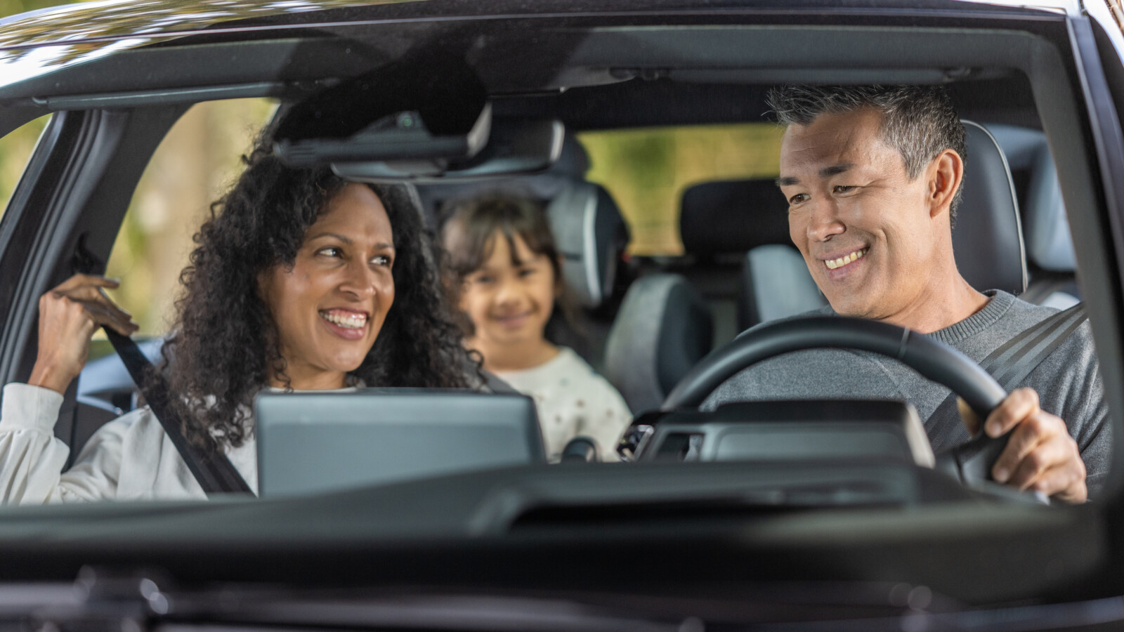 Happy family enjoying in car during road trip